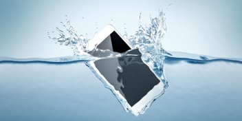 smartphone submerged in water with splashes