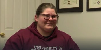 Sabra smiles with excitement while wearing her new hearing aids.