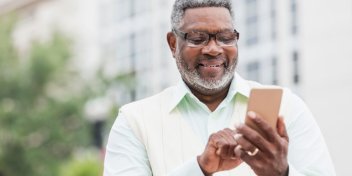 man pairing hearing device via Bluetooth on smartphone