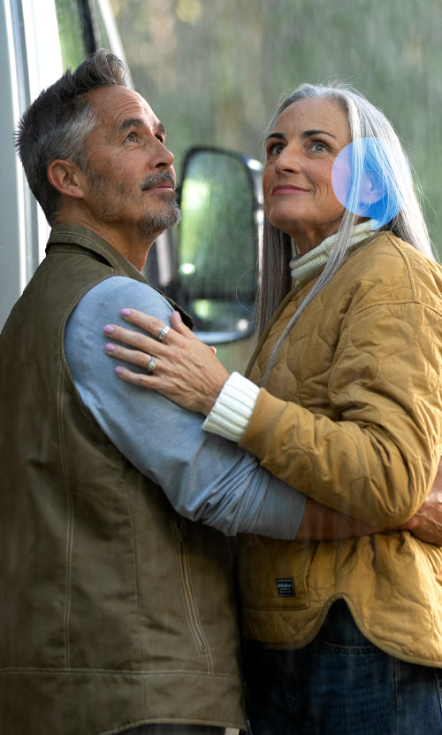 couple holding each other and smiling in the rain