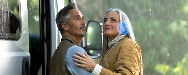 couple holding each other and smiling in the rain
