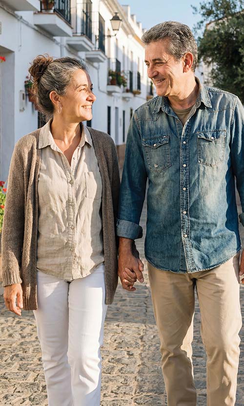 Couple walking and smiling at one another