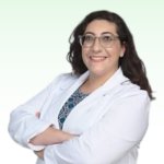 Eleni Santarelli, hearing care professional in a white coat