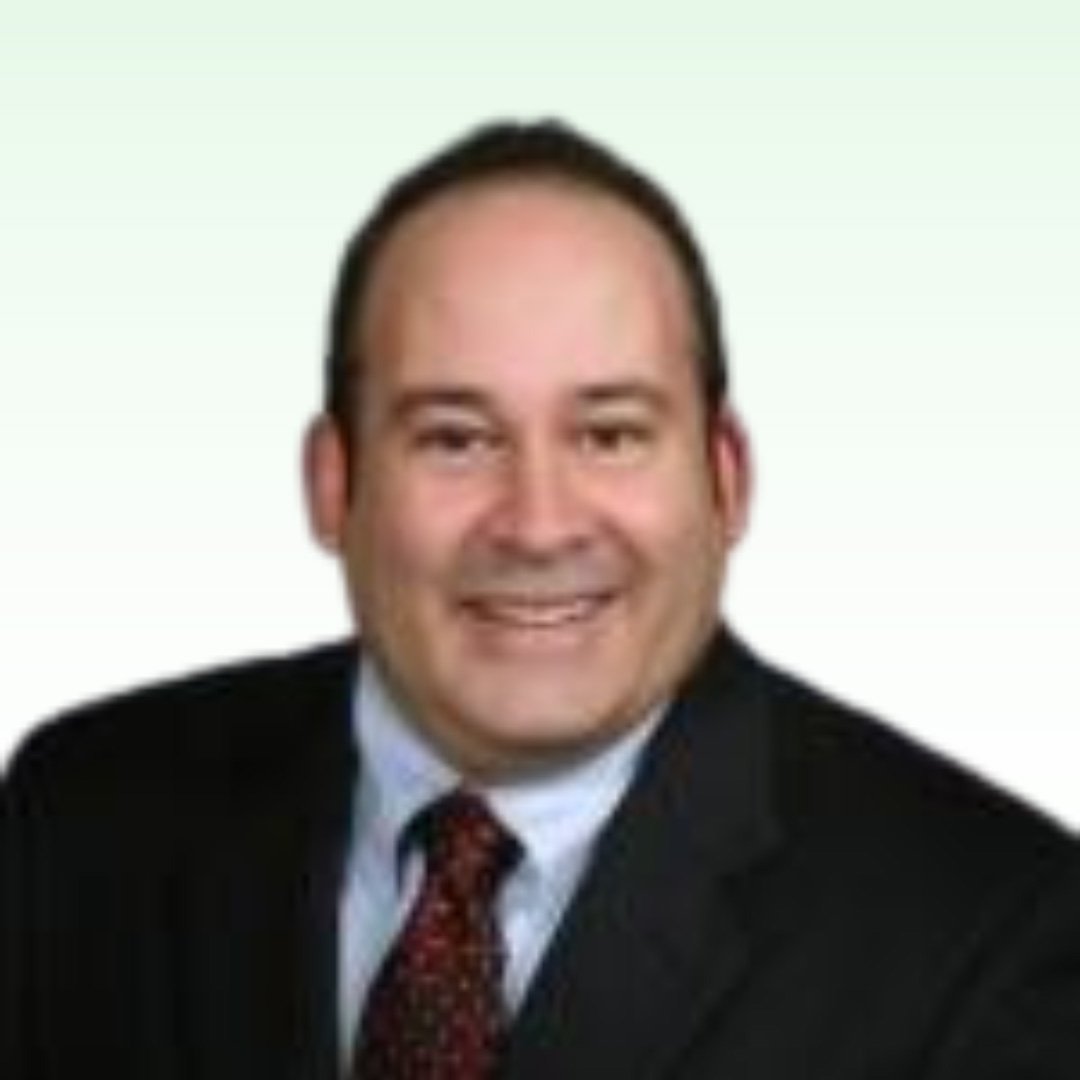 Kip Toderan, hearing care professional in formal attire.