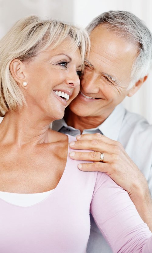 Couple hugging each other and smiling