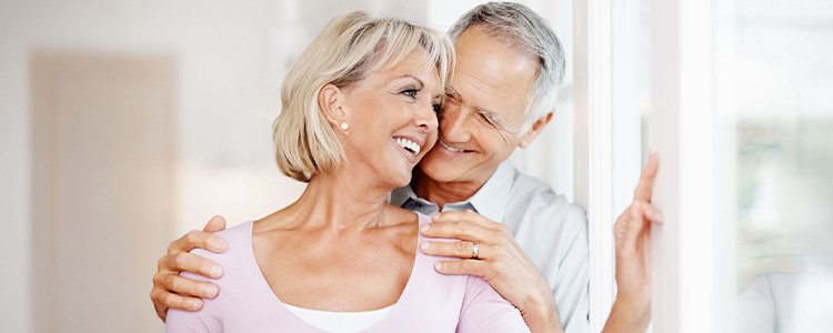 Couple hugging each other and smiling