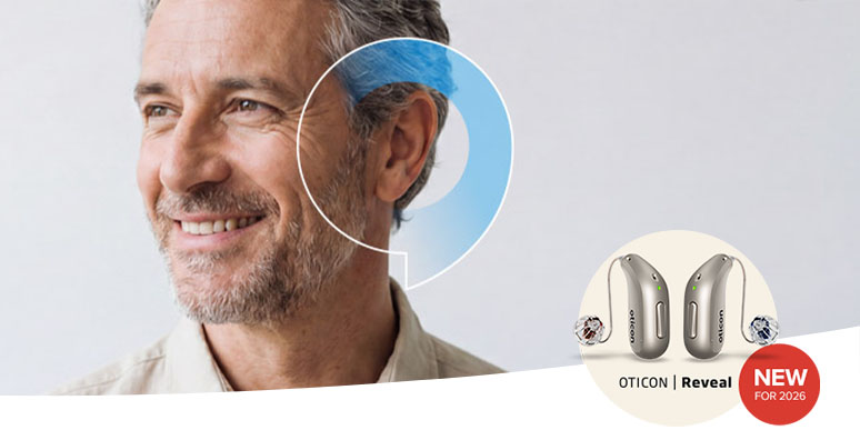 Man smiling wearing the NEW Oticon Reveal™