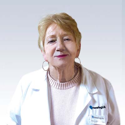Donna M. Fleckenstein, hearing care professional wearing a white lab coat with the HearingLife logo.