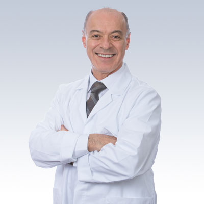 hearing care specialist in a white coat with arms crossed