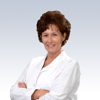 Allison Vaughn wearing a white lab coat with arms crossed on a professional gradient background.