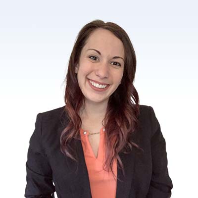 anna magers, hearing care professional wearing a black blazer and coral blouse