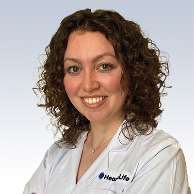 Danielle Madrigal, hearing care specialist at HearLife, wearing a white lab coat.