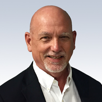 Dennis Freiheit, hearing care specialist in professional attire.