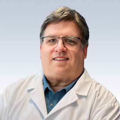 hearing care professional in a white coat with a neutral background