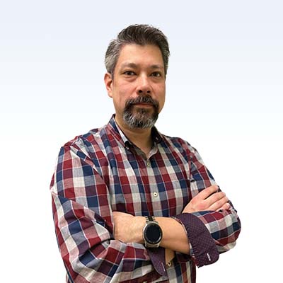 Man in a plaid shirt with arms crossed wearing a smartwatch against a gradient background.