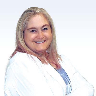 Hearing care professional Jaimie Avenall in a white lab coat.