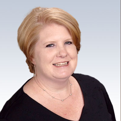 Jennifer Goldman, hearing care specialist, with short blonde hair and a professional black top against a gradient background.