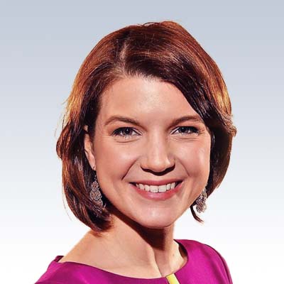 jennifer thomas, hearing care professional with short red hair wearing a pink blouse