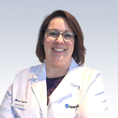 Jessie Fredine wearing a white HearingLife lab coat.
