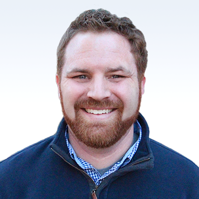 Justin Nations, hearing care professional wearing a navy jacket over a checkered shirt