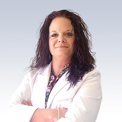 hearing care professional wearing a white coat with arms crossed