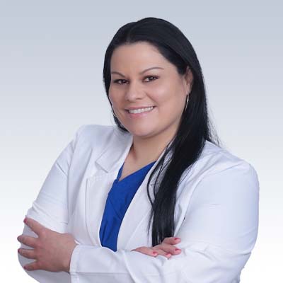 Laura Bradford, hearing care professional in a white coat with arms crossed.
