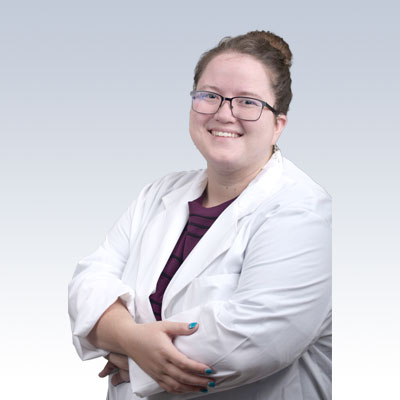 laura schauer, hearing care professional with arms crossed in a white coat