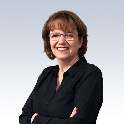 Leslie P Soiles posing confidently in professional attire against a gradient background.