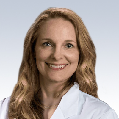 hearing care professional with long blonde hair wearing a white coat