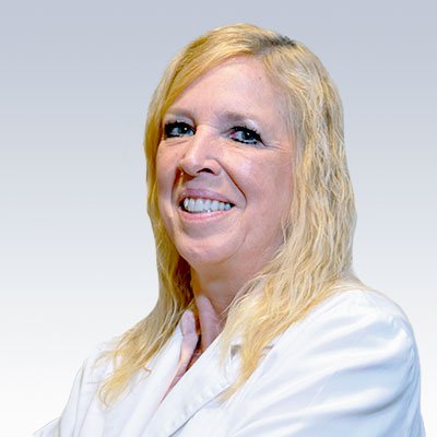 hearing care professional Lori Stephens in a white coat