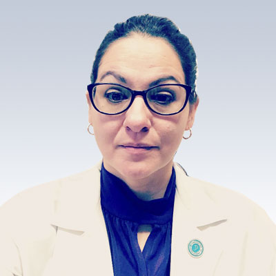 Lorinda Rose wearing a white coat with a professional appearance.