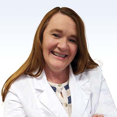 mary sloan, hearing care specialist in a white coat
