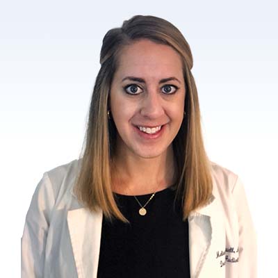 melissa colwell hearing care professional wearing a white coat