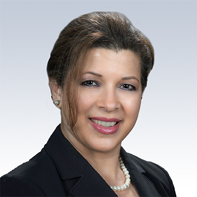 rashideh mehr, hearing care specialist wearing a black blazer and pearl necklace