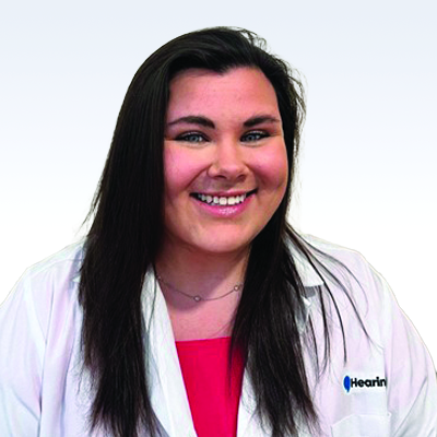 hearing care professional wearing a white coat with Hearing logo
