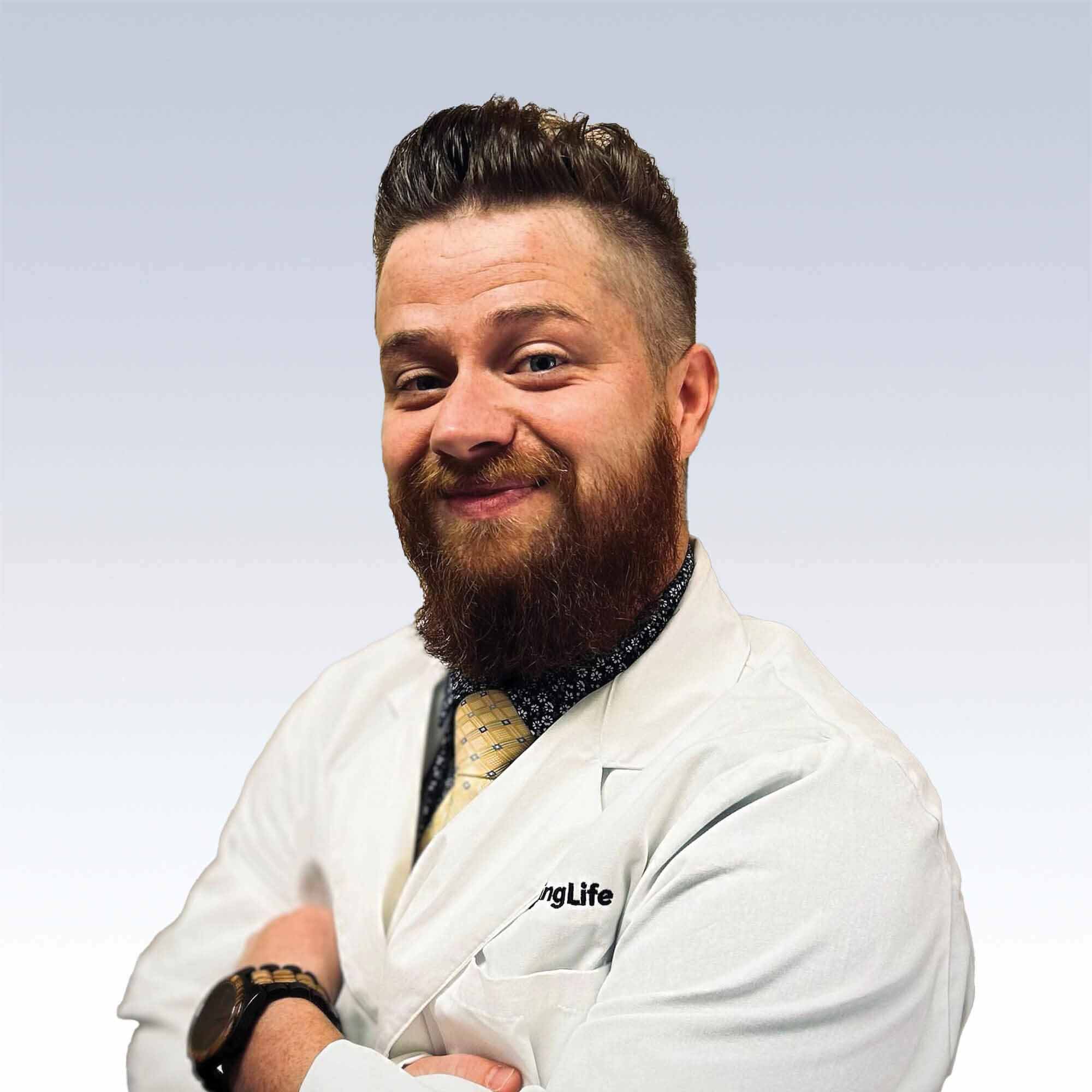 hearing care professional wearing a white lab coat with a neutral background