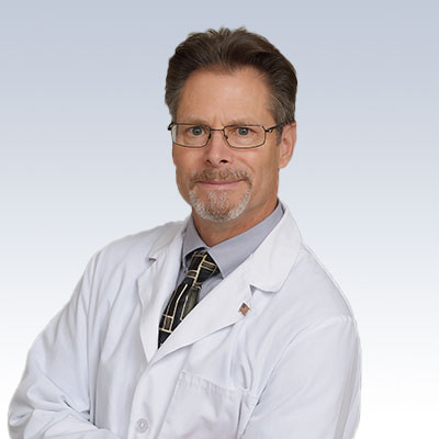 Hearing care professional Robert Bennett wearing a white coat.