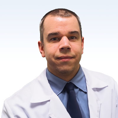 hearing care professional wearing a lab coat and tie