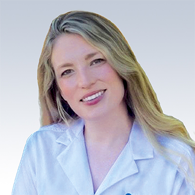 Shannon Askew wearing a white lab coat with long blonde hair against a gradient background.