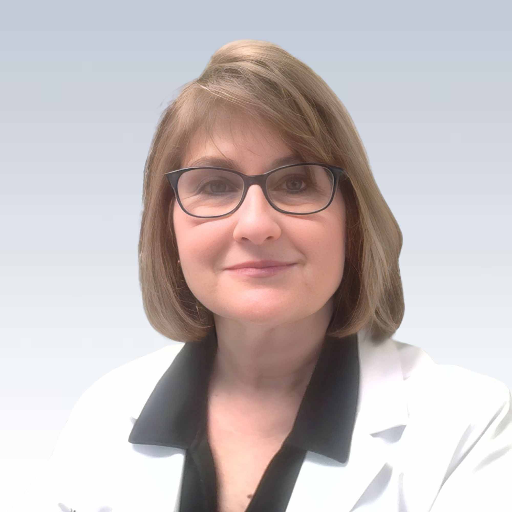 sharon stoor, hearing care specialist wearing a white coat, light background