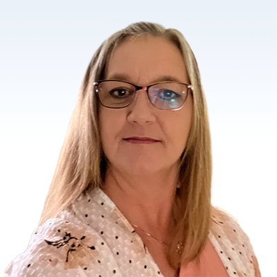 A woman wearing glasses and a polka-dotted shirt looks directly at the camera. She has long, straight hair. The background is a plain, light gradient from white to pale blue.