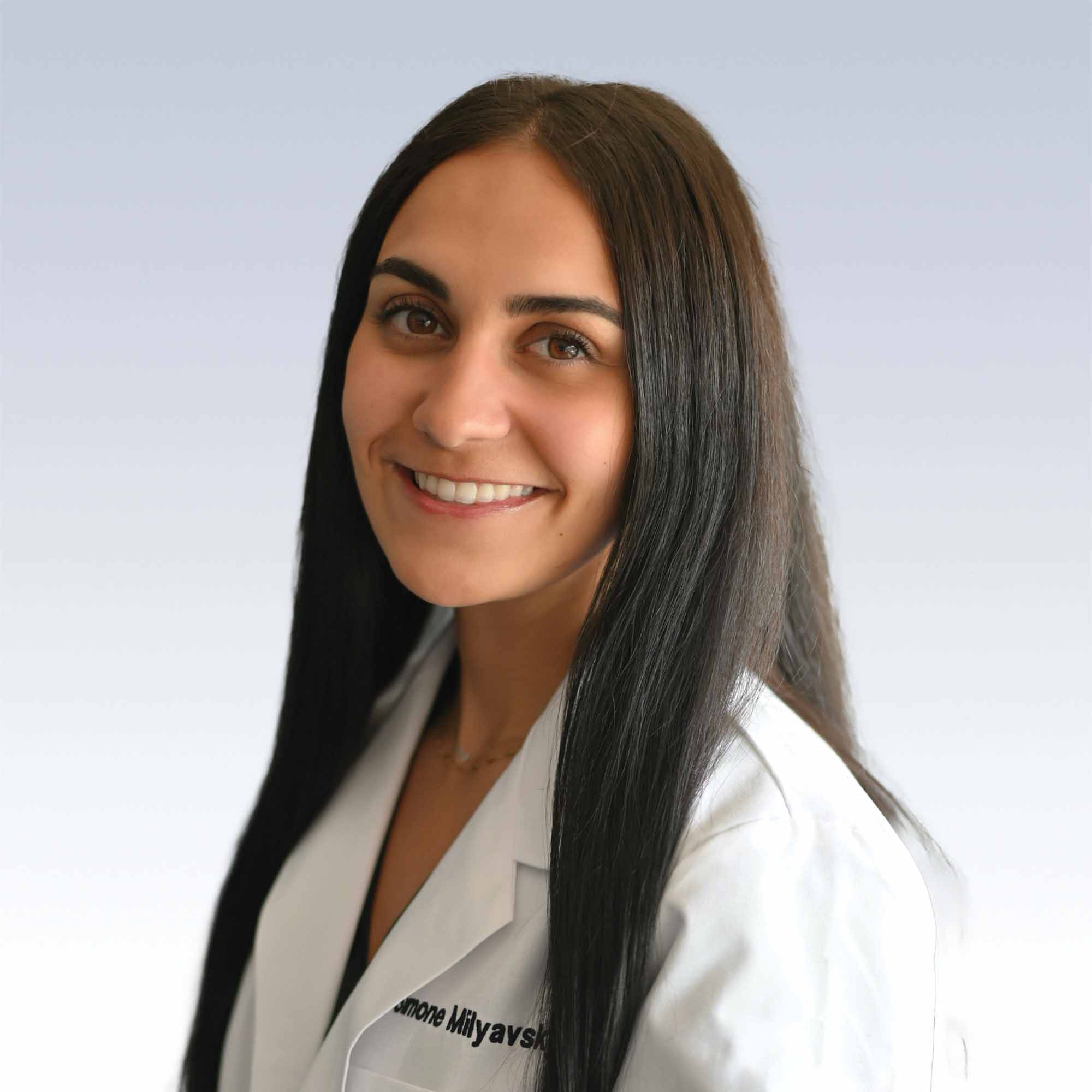 simone milyavsky, hearing care specialist wearing a professional white coat