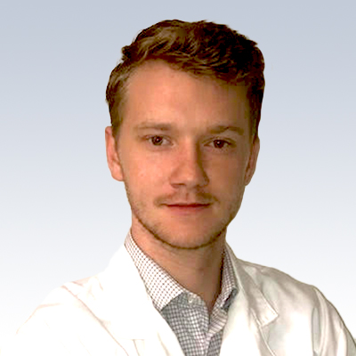 Hearing care professional in a white coat.
