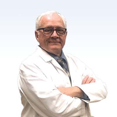 hearing care professional in a white coat with arms crossed