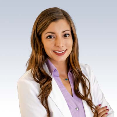 hearing care professional wearing a white coat with long wavy brown hair