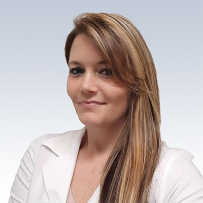 hearing care professional with long blonde hair wearing a white coat