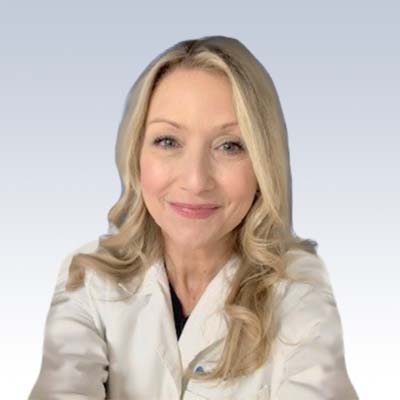 Hearing care professional Wendy Freihart in a white lab coat.