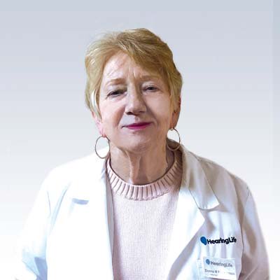 Donna M. Fleckenstein, hearing care professional wearing a white lab coat with the HearingLife logo.