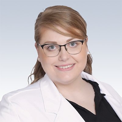 brianne holley, hearing care professional wearing a white coat