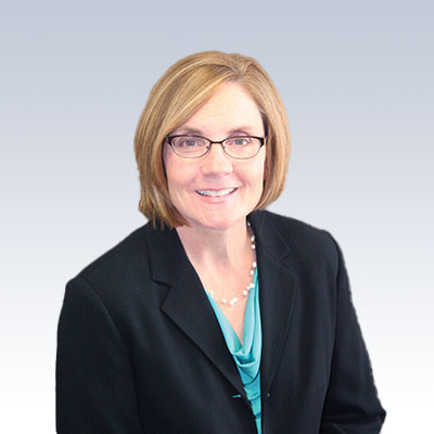 Catherine B. Grewell in professional attire against a gradient background.